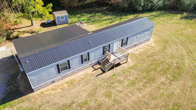 a view of roof deck with a yard and a floor to ceiling window