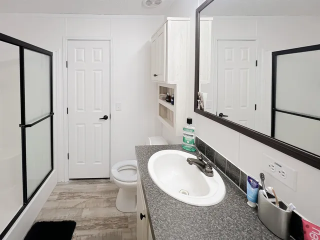 a bathroom with a tub sink and a window