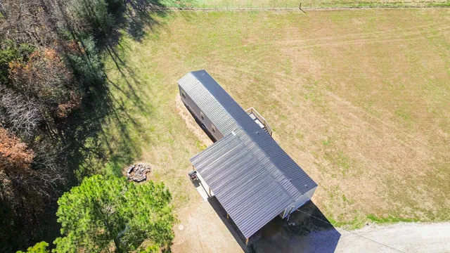 a view of a balcony with wooden floor and a tree