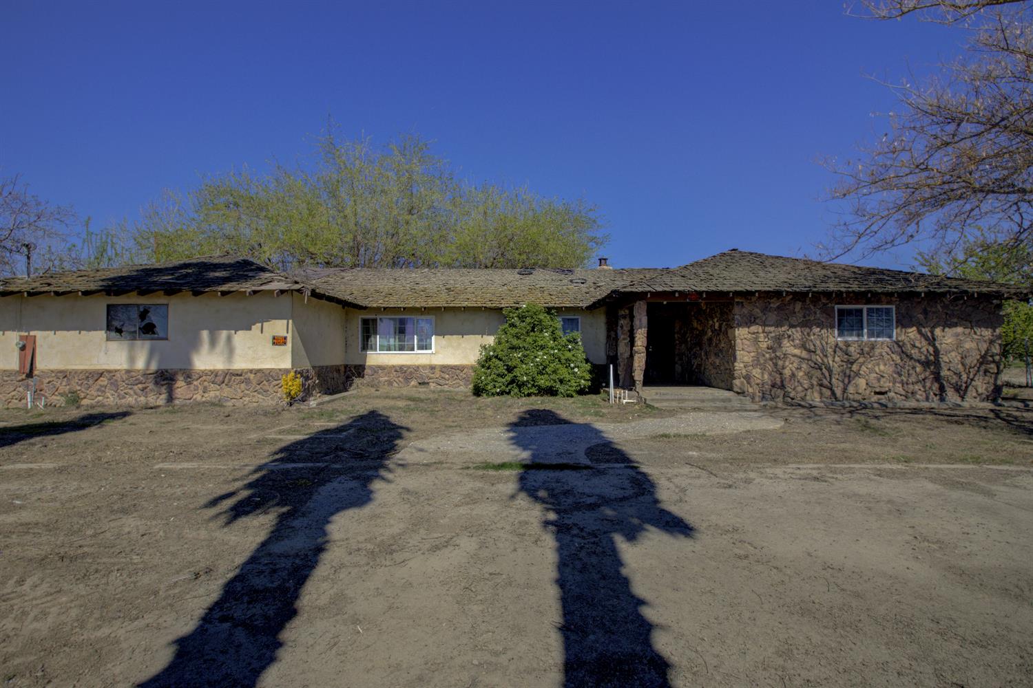 873 Loquat Avenue Patterson, CA 95363 - Photo 1 of 35 a front view of a house with a yard and garage