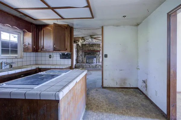 a kitchen with sink cabinets and window