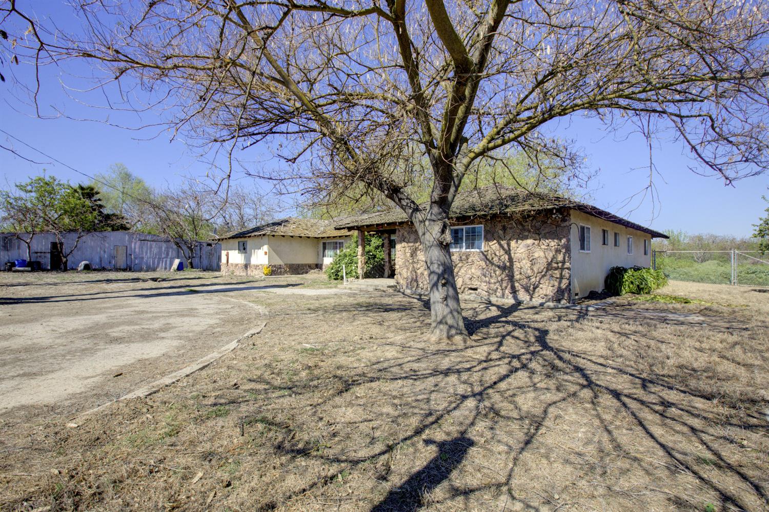 873 Loquat Avenue Patterson, CA 95363 - Photo 2 of 35 a front view of a house with a yard and garage