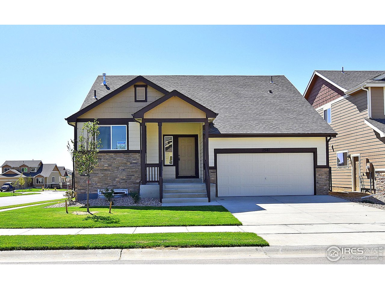 2310 Sublime Drive Windsor, CO 80550 - Photo 1 of 37 a front view of a house with a garden and garage