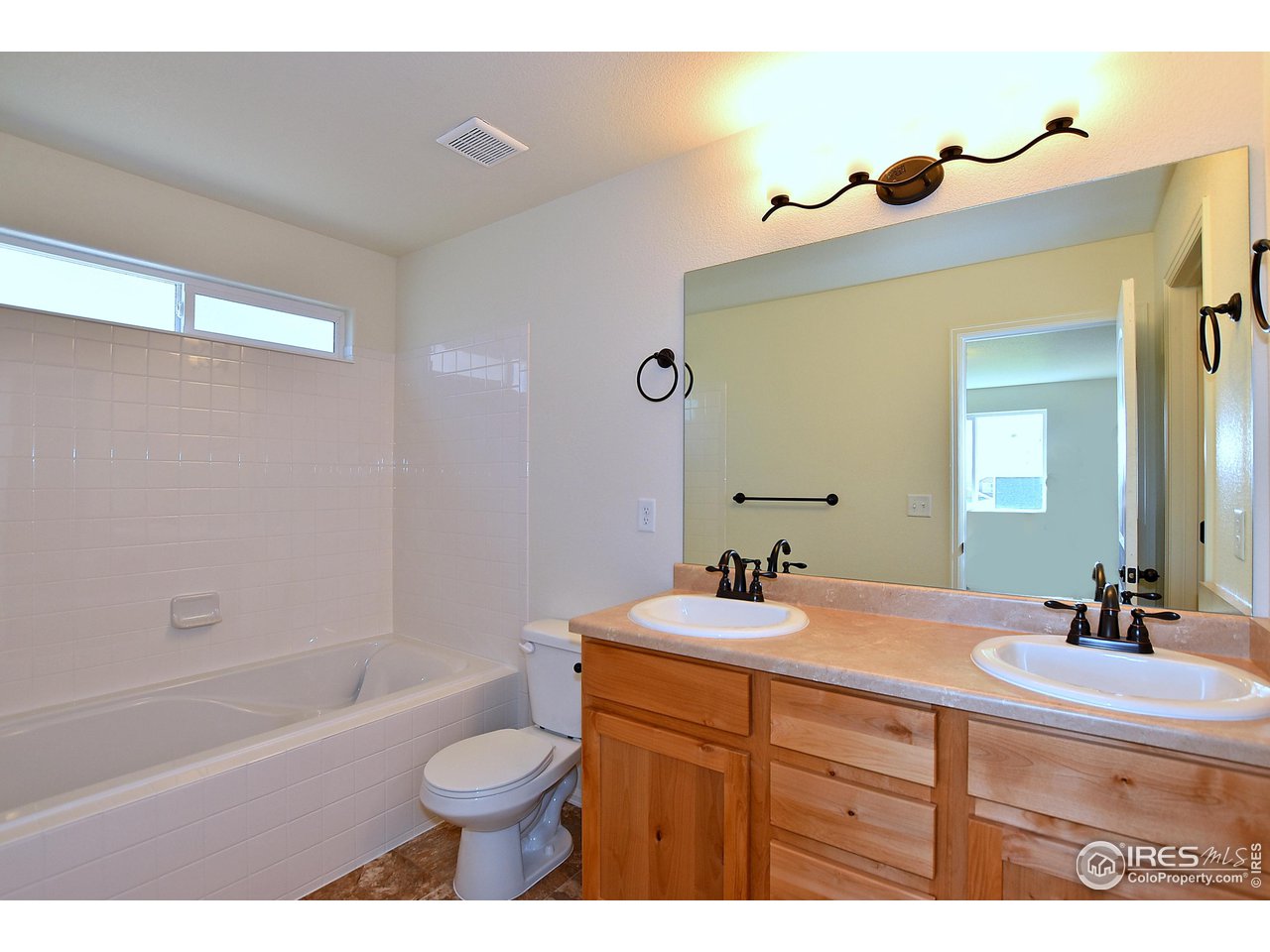 2310 Sublime Drive Windsor, CO 80550 - Photo 23 of 37 a bathroom with a sink a toilet and a mirror