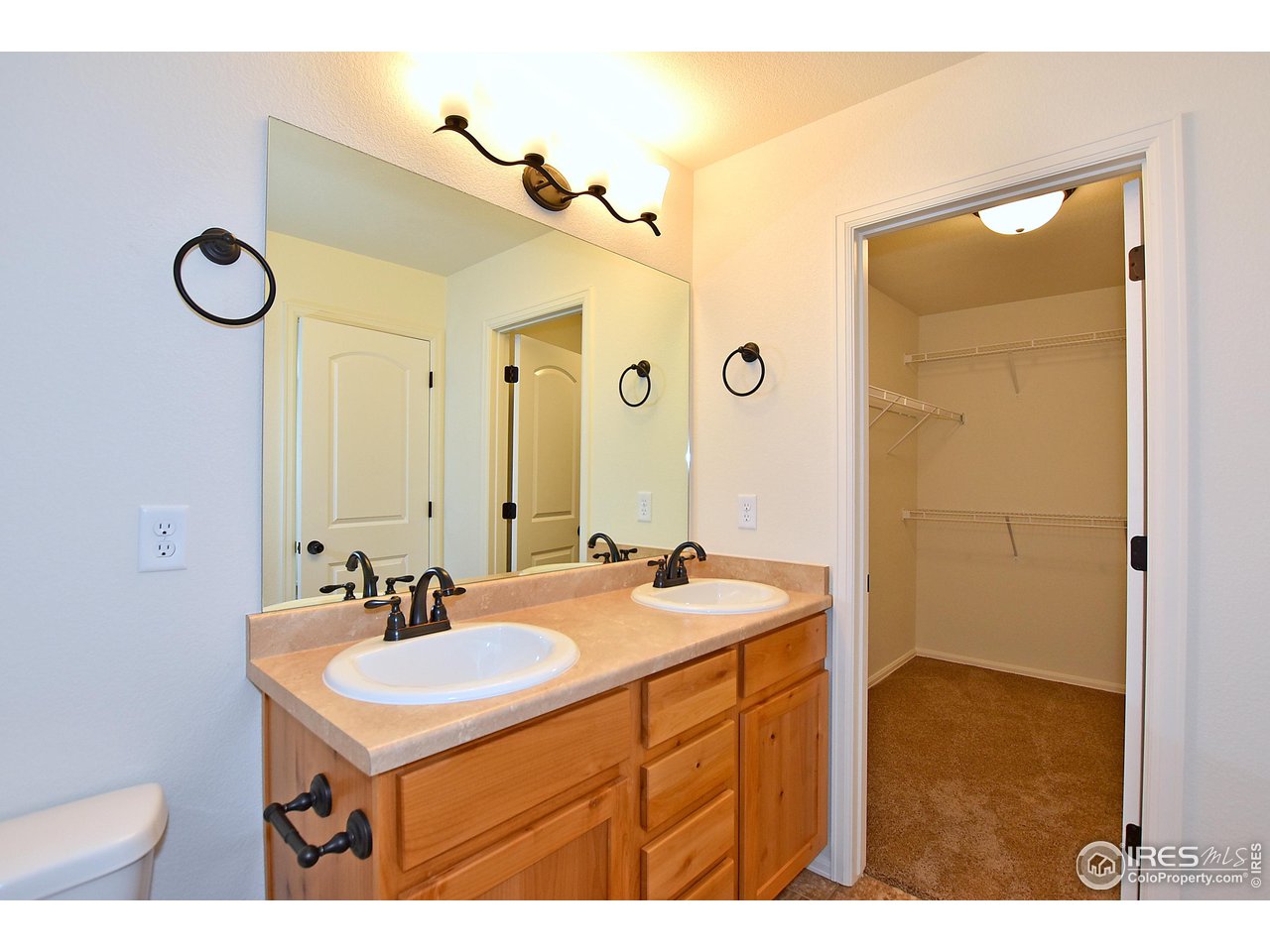 2310 Sublime Drive Windsor, CO 80550 - Photo 25 of 37 a bathroom with a sink and a mirror