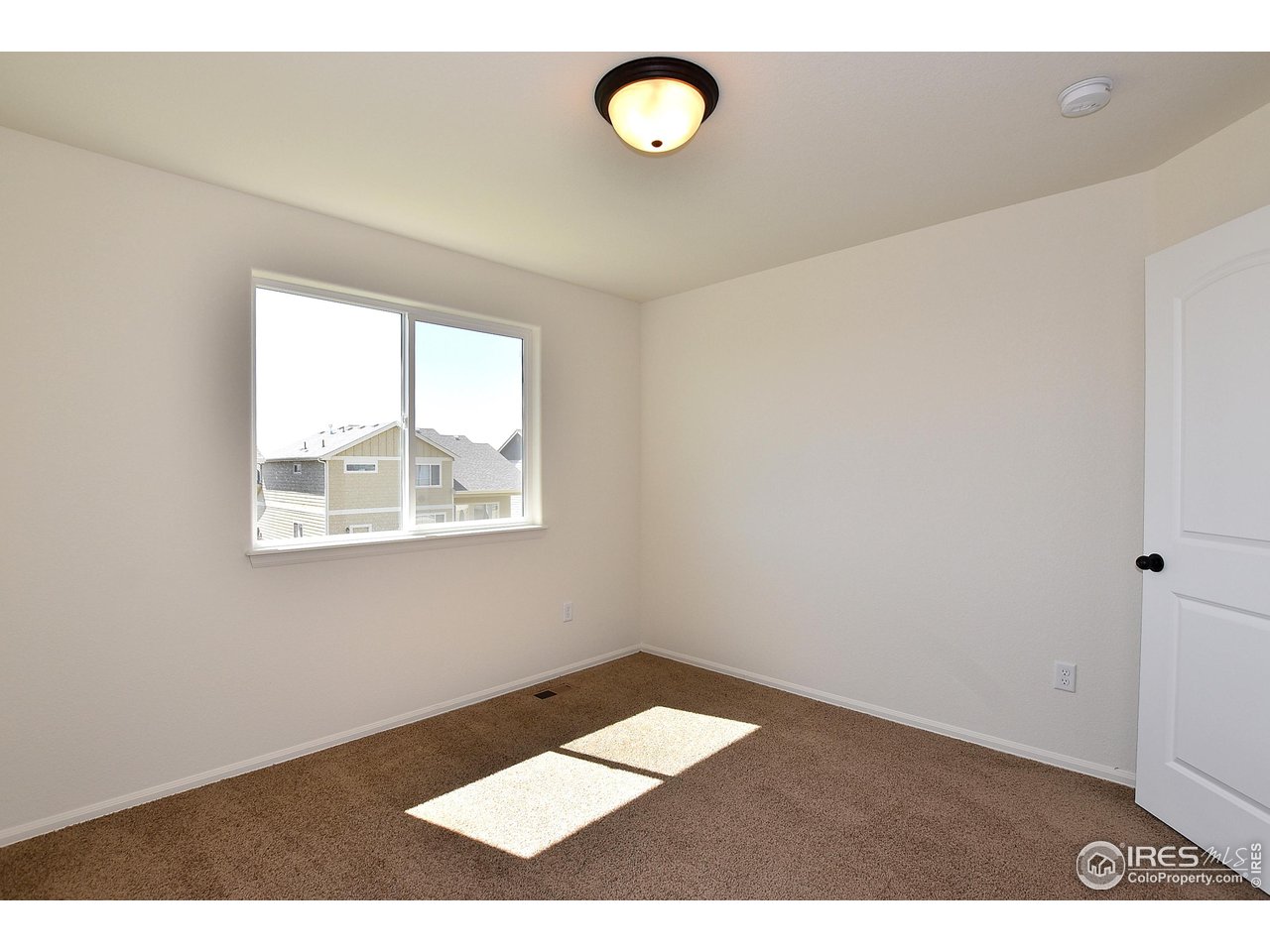 2310 Sublime Drive Windsor, CO 80550 - Photo 27 of 37 a view of an empty room with a window