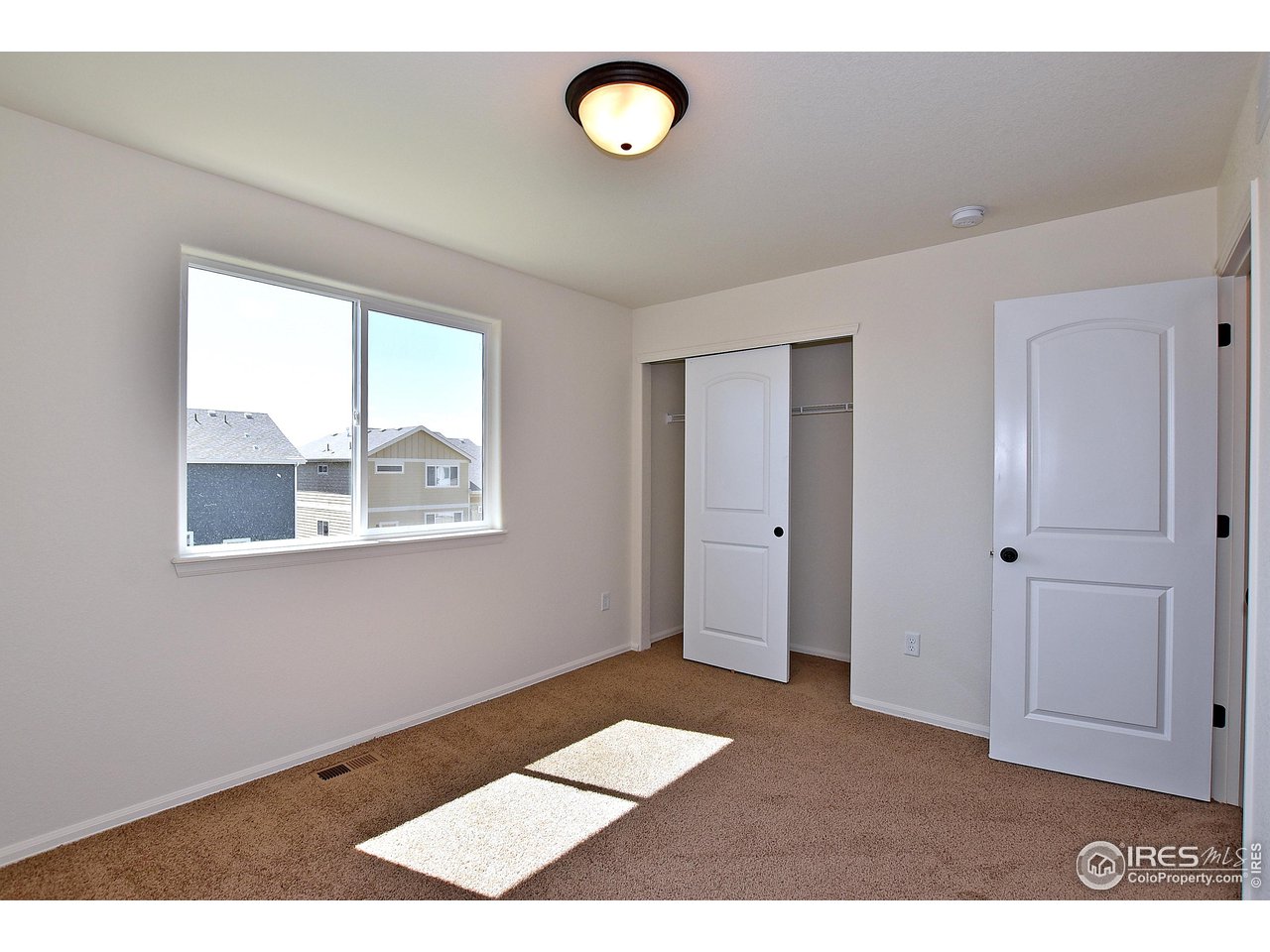 2310 Sublime Drive Windsor, CO 80550 - Photo 30 of 37 a view of an empty room with a window
