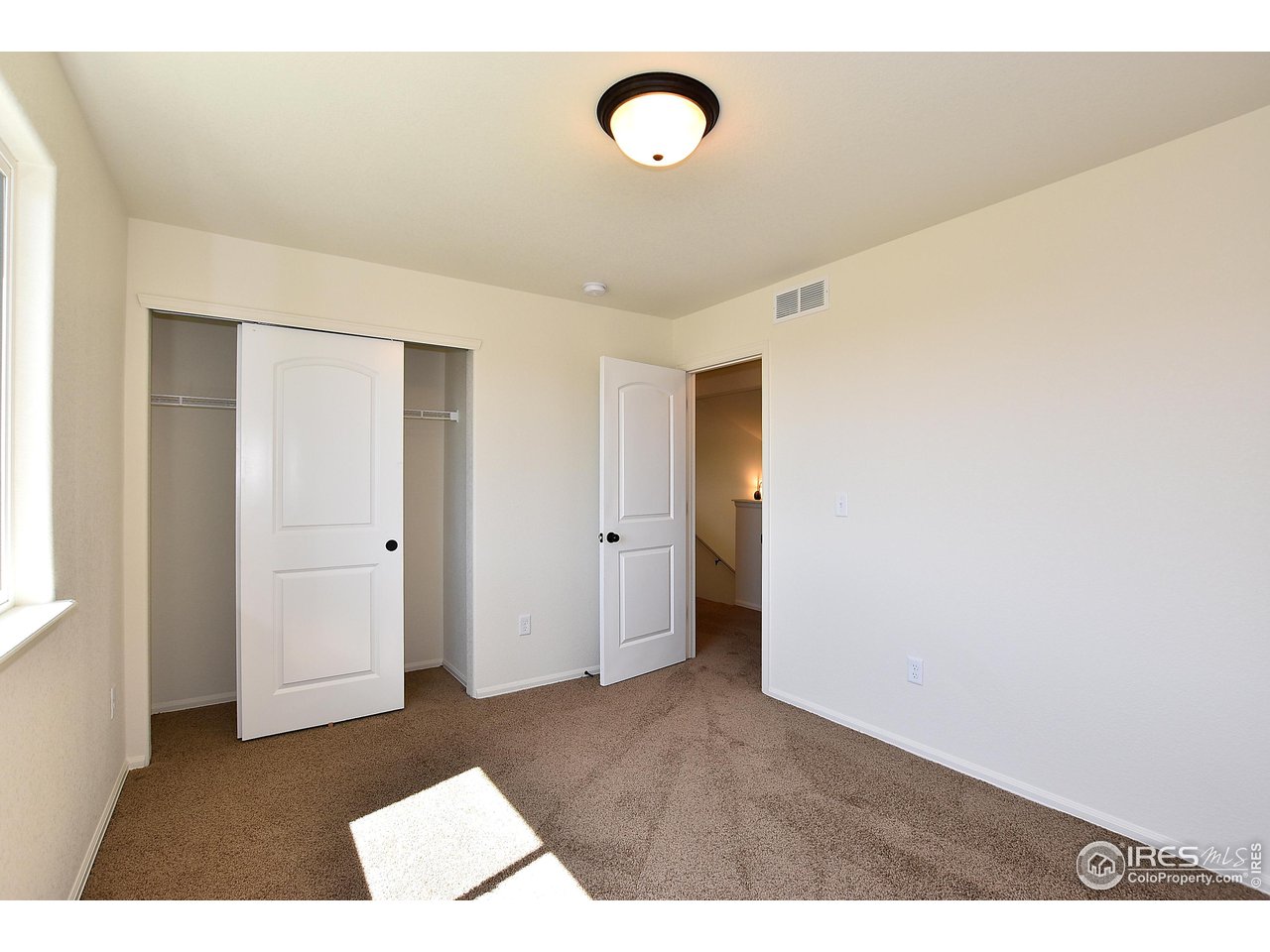 2310 Sublime Drive Windsor, CO 80550 - Photo 31 of 37 a view of a room with wooden floor