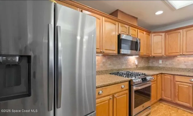 a kitchen with granite countertop a sink and a counter top space