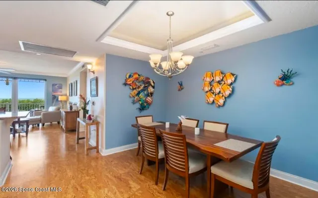 a dining room with furniture and a chandelier