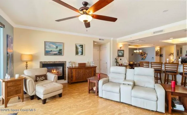 a living room with furniture a flat screen tv and a large window