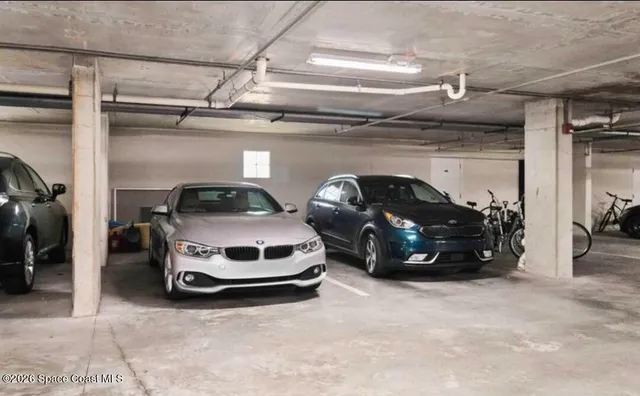 a dining room with furniture and a floor to ceiling window
