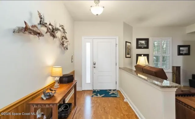 a living room with hard wood floors and a fireplace