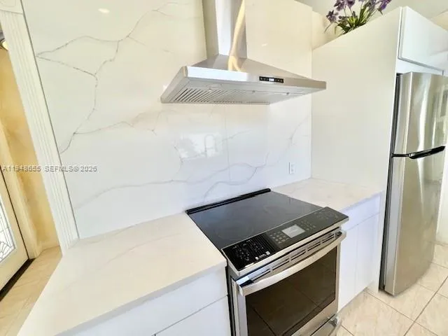 a view of a kitchen with an empty space and a window