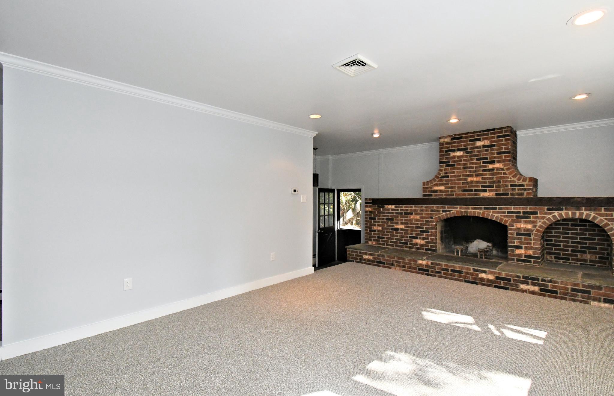 838 Store Road Harleysville, PA 19438 - Photo 25 of 65 a view of a livingroom with a fireplace and a chandelier