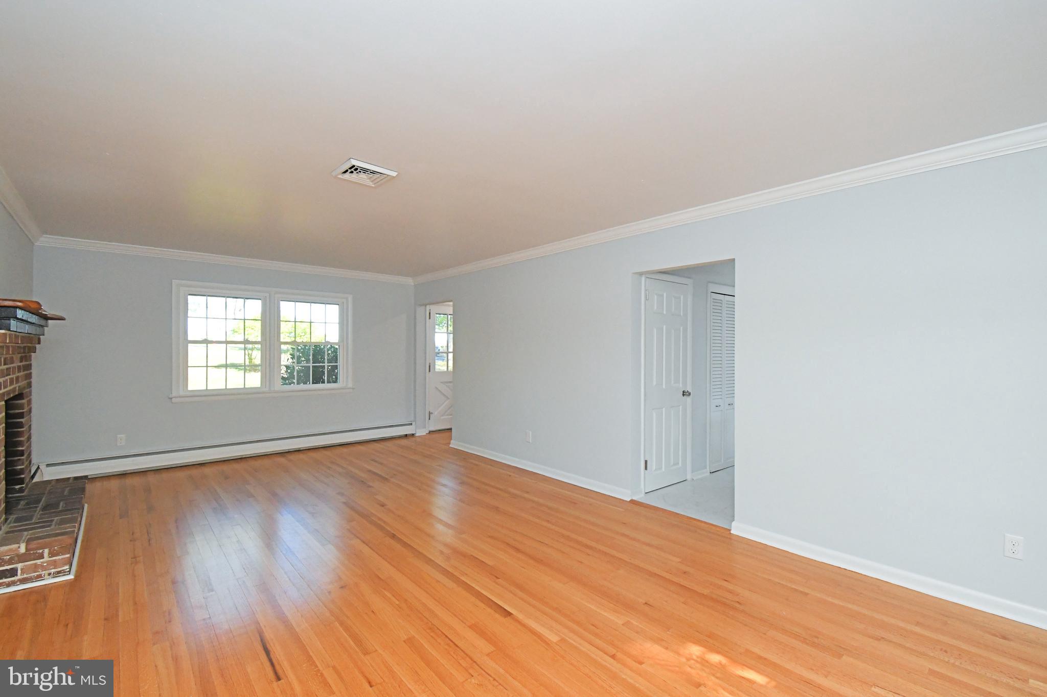 838 Store Road Harleysville, PA 19438 - Photo 8 of 65 a view of an empty room with wooden floor and a window
