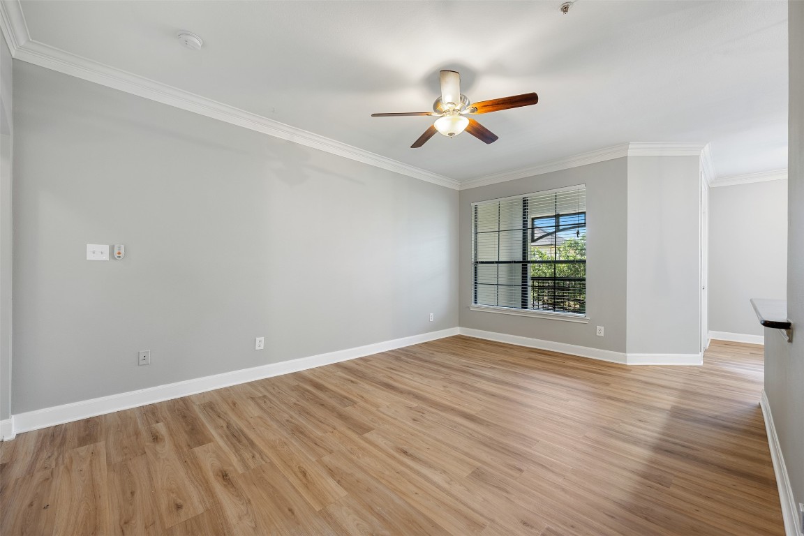 7701 Rialto Boulevard, Unit 1433 Austin, TX 78735 - Photo 15 of 31 a view of an empty room with wooden floor and a window