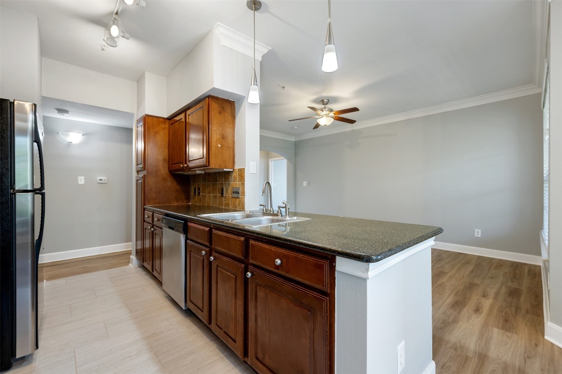 7701 Rialto Boulevard, Unit 1433 Austin, TX 78735 - Photo 7 of 31 a kitchen with kitchen island a sink stove and refrigerator