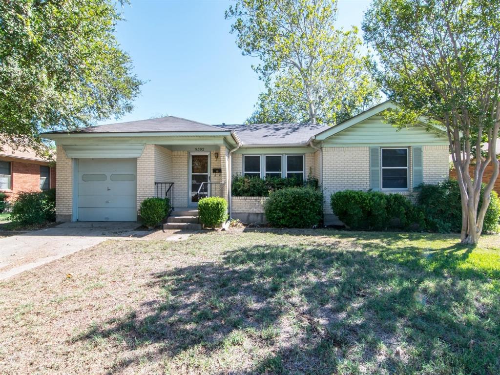 9302 Piper Lane Dallas, TX 75228 - Photo 2 of 13 a front view of a house with a yard and trees