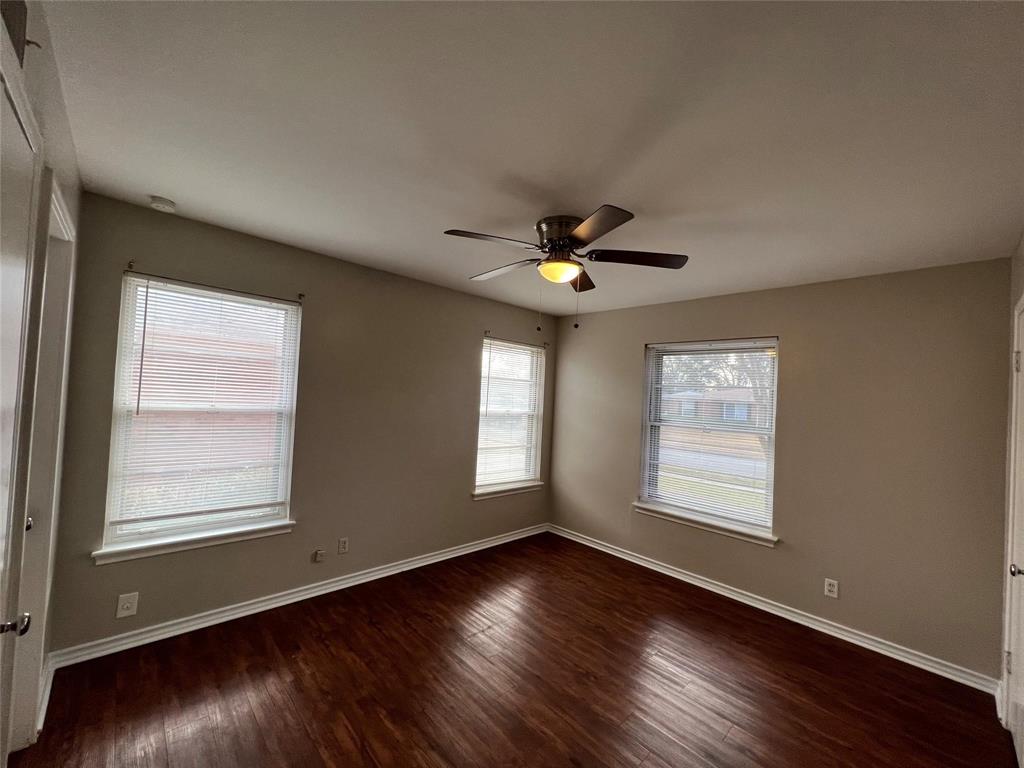 9302 Piper Lane Dallas, TX 75228 - Photo 3 of 13 a view of an empty room with wooden floor and a window