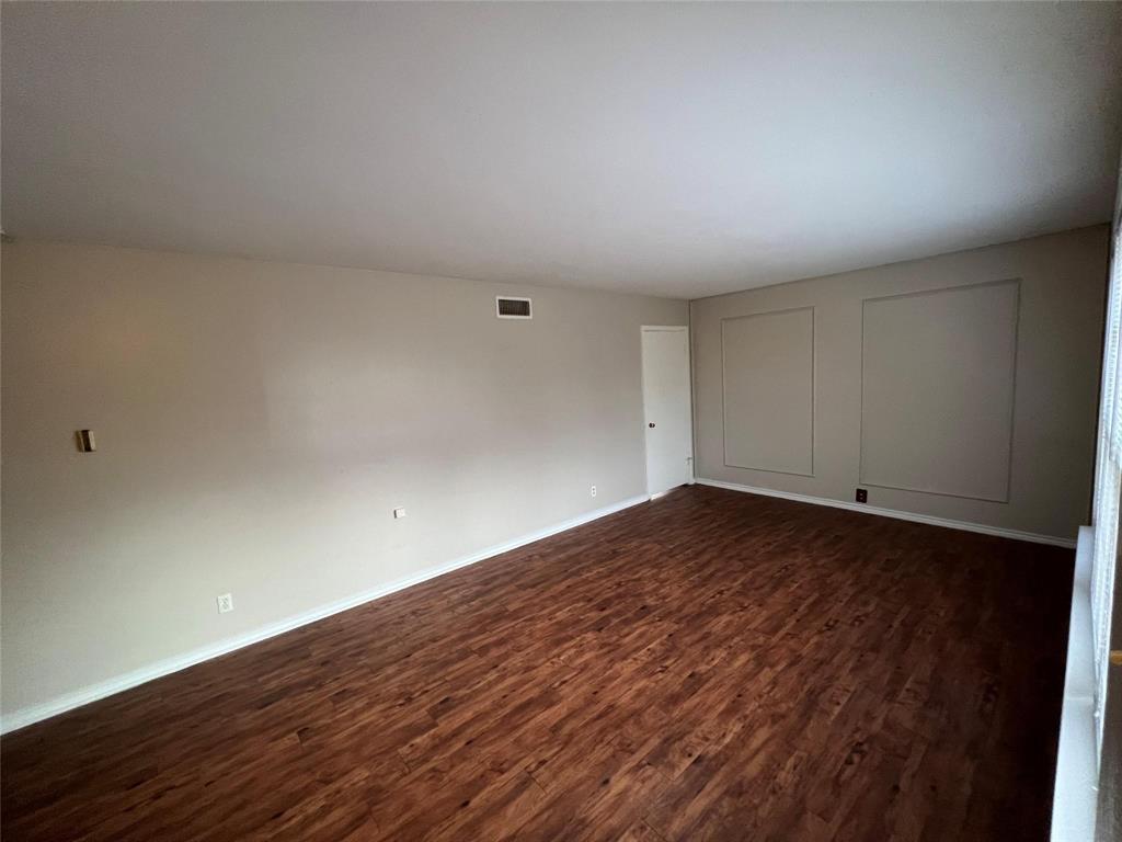 9302 Piper Lane Dallas, TX 75228 - Photo 7 of 13 a view of empty room with wooden floor