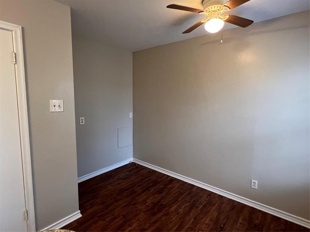9302 Piper Lane Dallas, TX 75228 - Photo 9 of 13 an empty room with wooden floor and fan