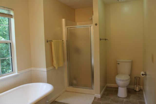 1500 CC Road Kingston Springs, TN 37082 - Photo 14 of 19 Always nice to have a separate shower and a tub. New shower door along with new fixtures and towel racks and toilet.