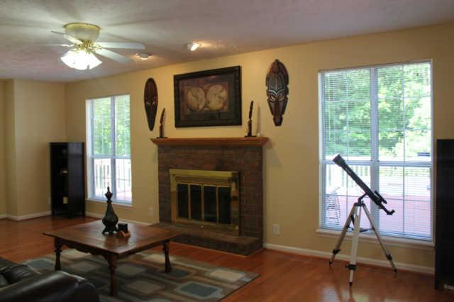 1500 CC Road Kingston Springs, TN 37082 - Photo 6 of 19 Another view of the living room. Notice the spotlights above the fireplace, hardwood floors that shine, windows everywhere. This home has everything you always wanted and more!