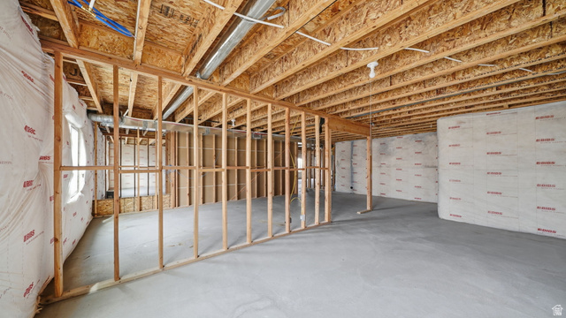 6017 North Sheps Road, Unit C211 Eagle Mountain, UT 84005 - Photo 24 of 25 Unfinished basement with concrete flooring, exposed wooden joists, framed interior walls, and insulated exterior walls