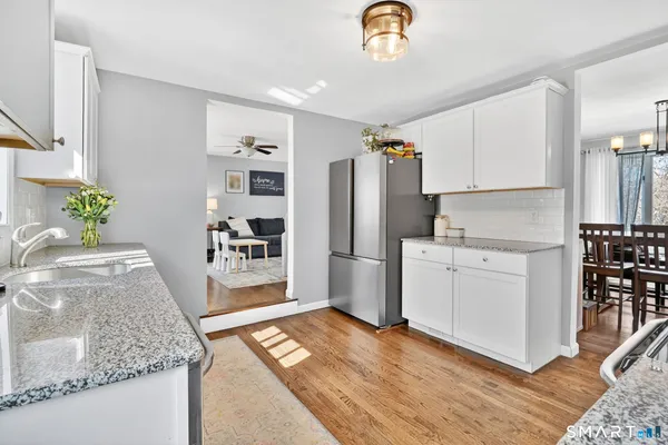 a bathroom with a sink a toilet and a window