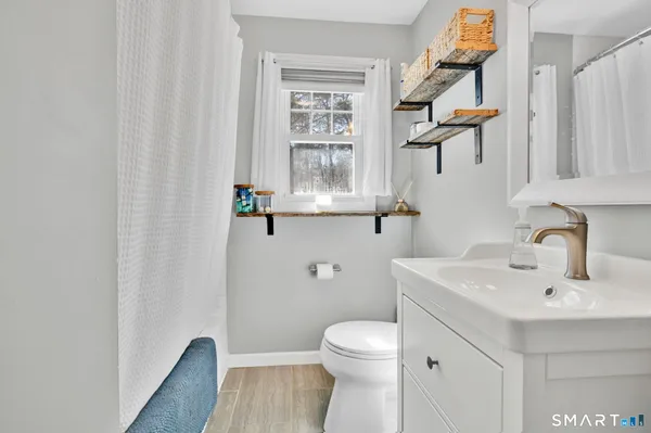 a bedroom with a bed couch and window