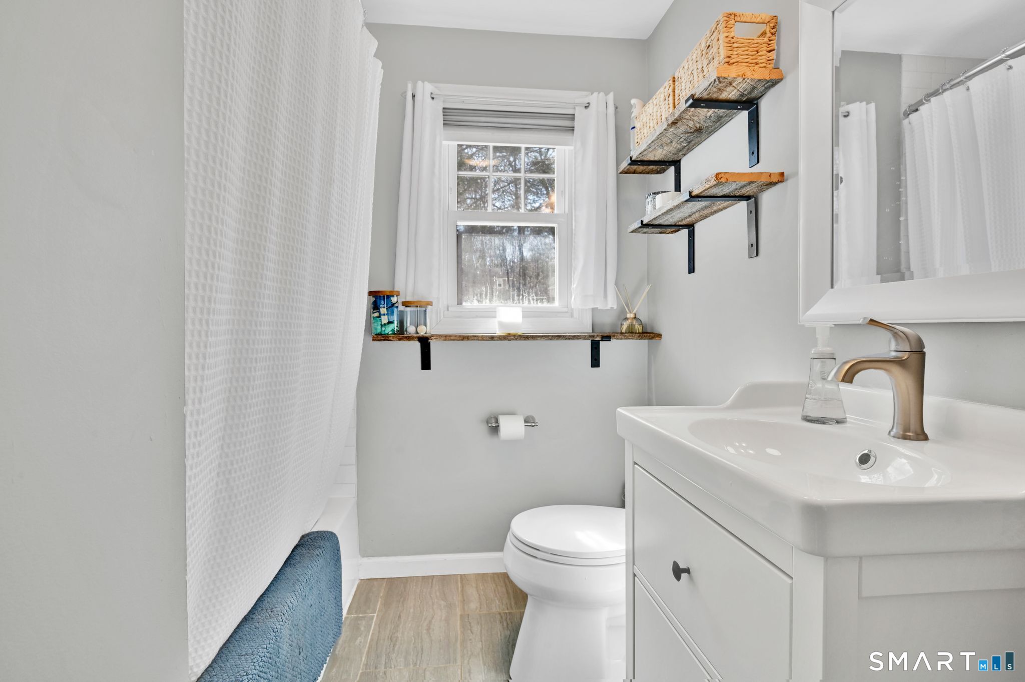 256 Albrecht Road Torrington, CT 06790 - Photo 12 of 31 a bathroom with a sink a toilet and a window