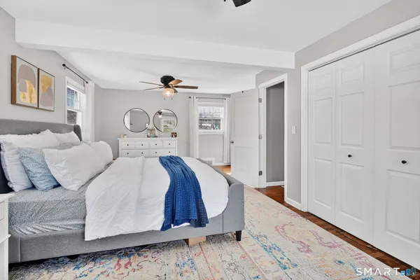 a bedroom with a bed and a dresser in it