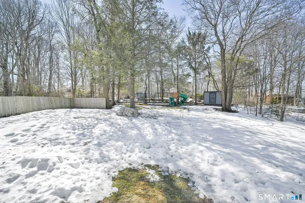 a view of a house with backyard and a tree
