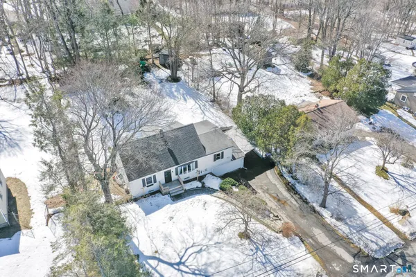 a view of a house with a big yard and large trees
