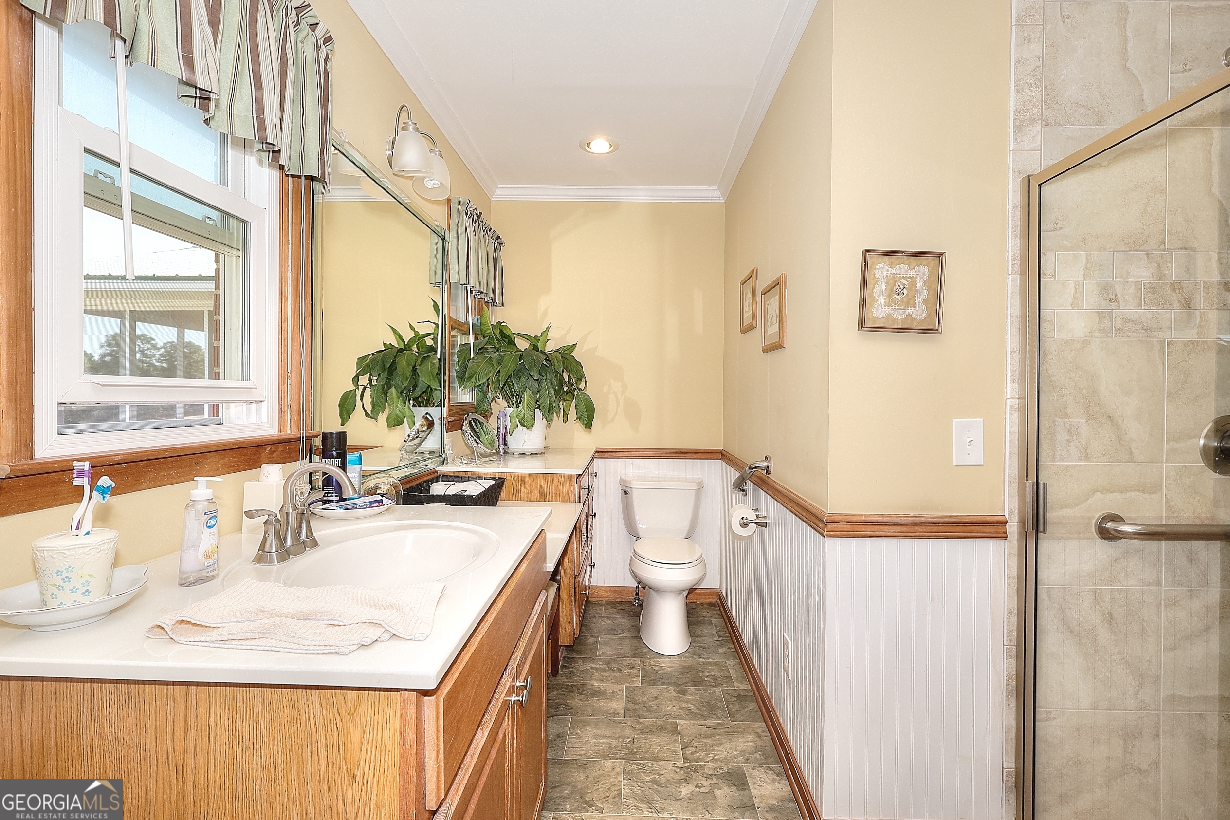 2850 Liberty Church Road White Plains, GA 30678 - Photo 13 of 33 a bathroom with a granite countertop sink a mirror a vanity and a shower