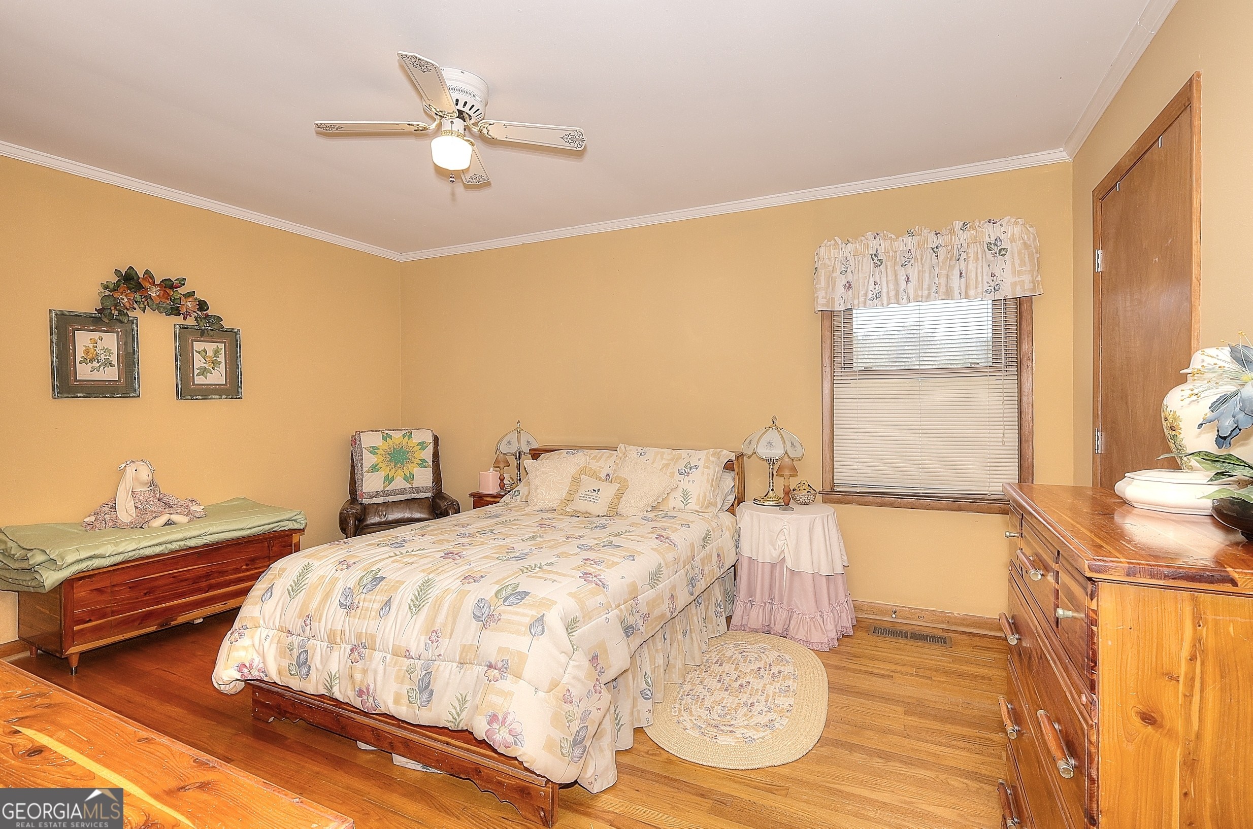 2850 Liberty Church Road White Plains, GA 30678 - Photo 14 of 33 a bedroom with a bed and a chandelier