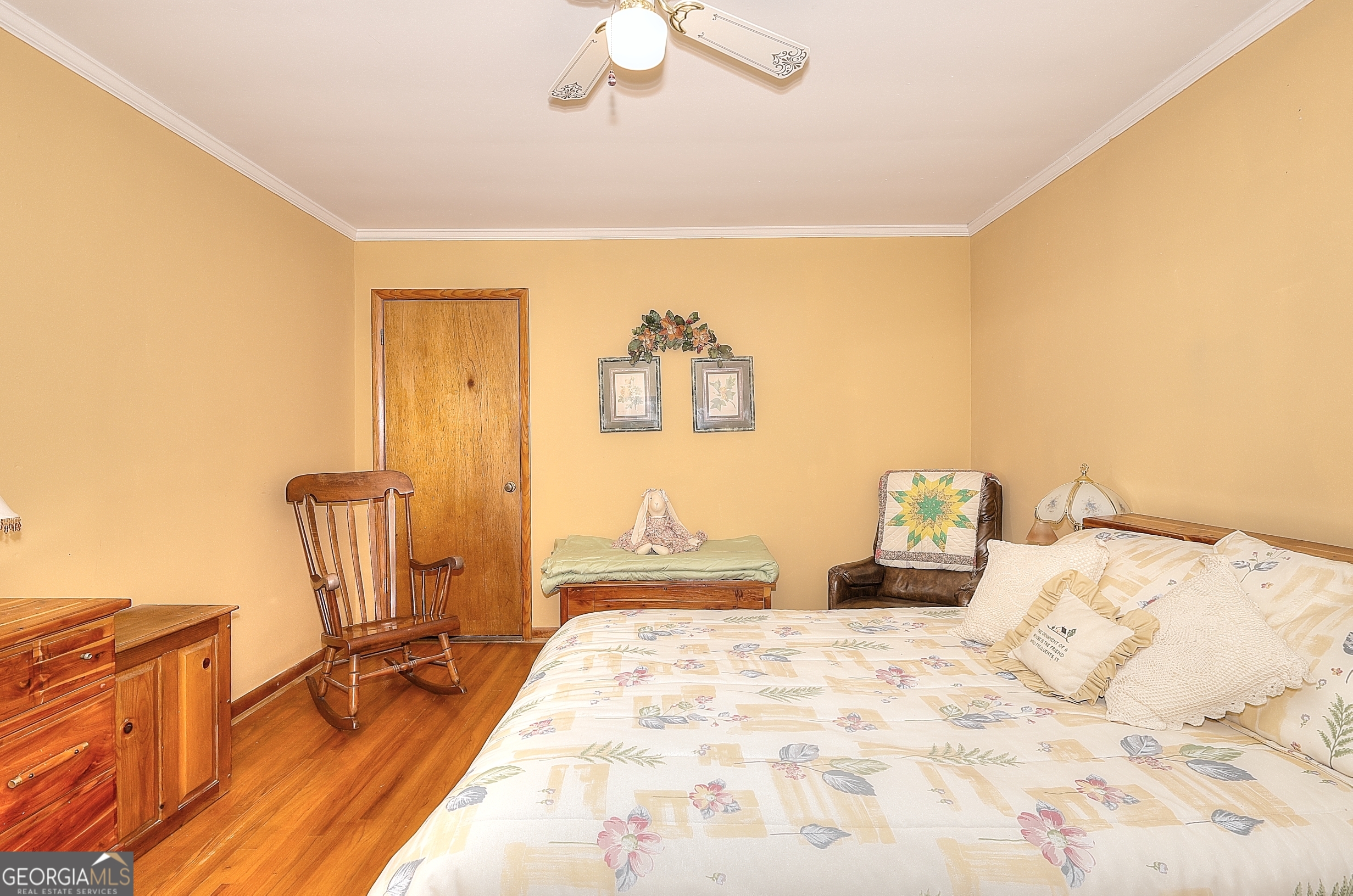2850 Liberty Church Road White Plains, GA 30678 - Photo 15 of 33 a bedroom with a bed and a chandelier