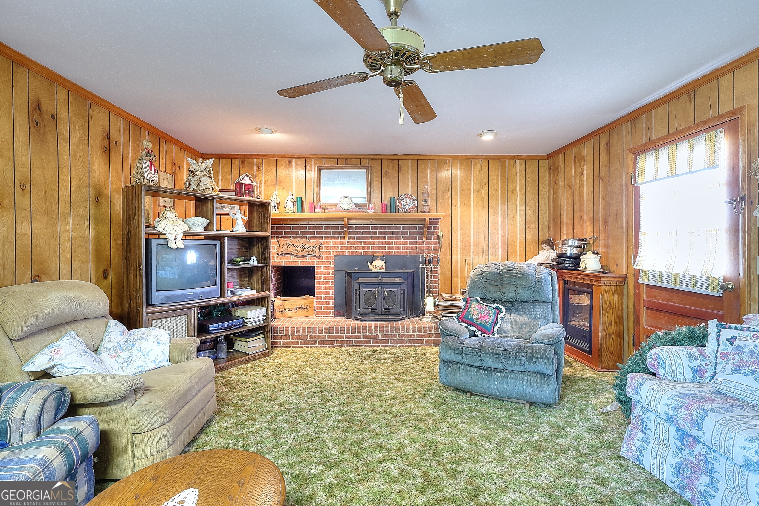2850 Liberty Church Road White Plains, GA 30678 - Photo 19 of 33 a living room with furniture a fireplace and a flat screen tv