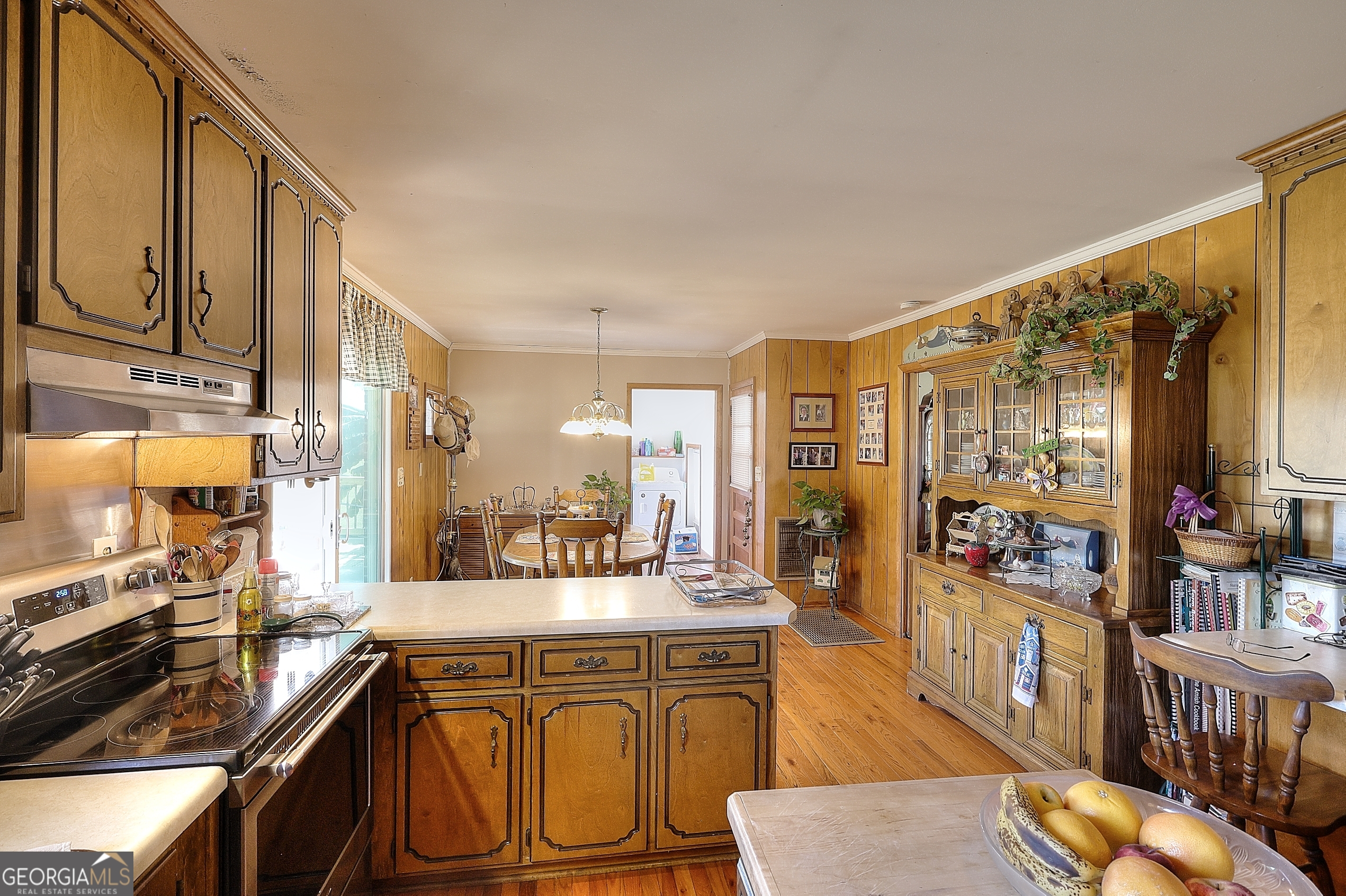 2850 Liberty Church Road White Plains, GA 30678 - Photo 9 of 33 a open kitchen with stainless steel appliances granite countertop a refrigerator a stove and a wooden cabinets with wooden floor