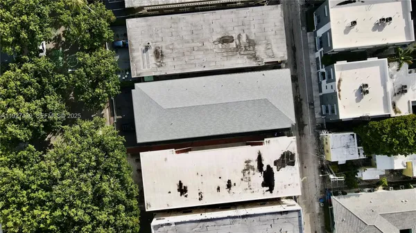 a view of a lake with a yard and large trees