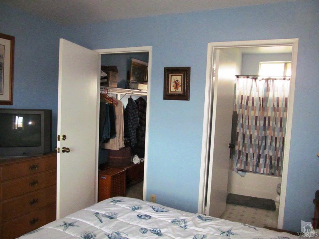 4508 Apricot Road, Unit A Simi Valley, CA 93063 - Photo 14 of 27 a bedroom with a bed and a mirror
