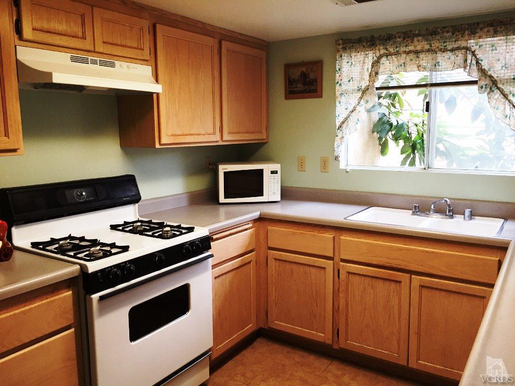 4508 Apricot Road, Unit A Simi Valley, CA 93063 - Photo 9 of 27 a kitchen with granite countertop stainless steel appliances a sink stove and cabinets