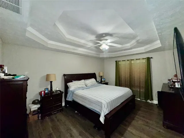 a bedroom with bed and wooden floor