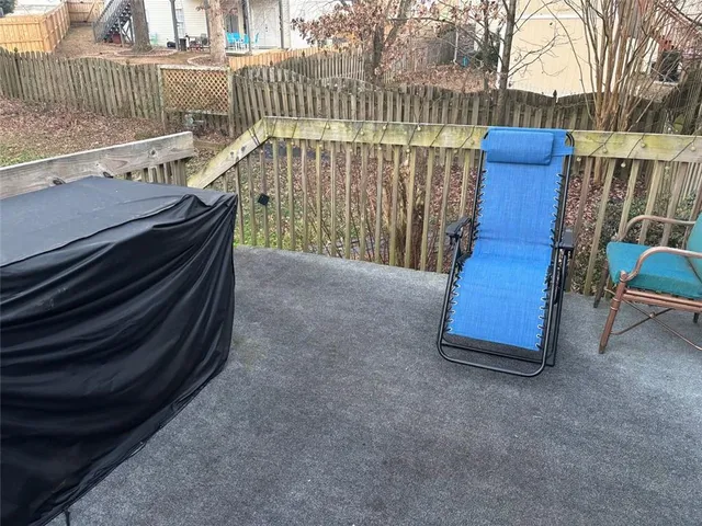 a view of a porch with a table and chairs