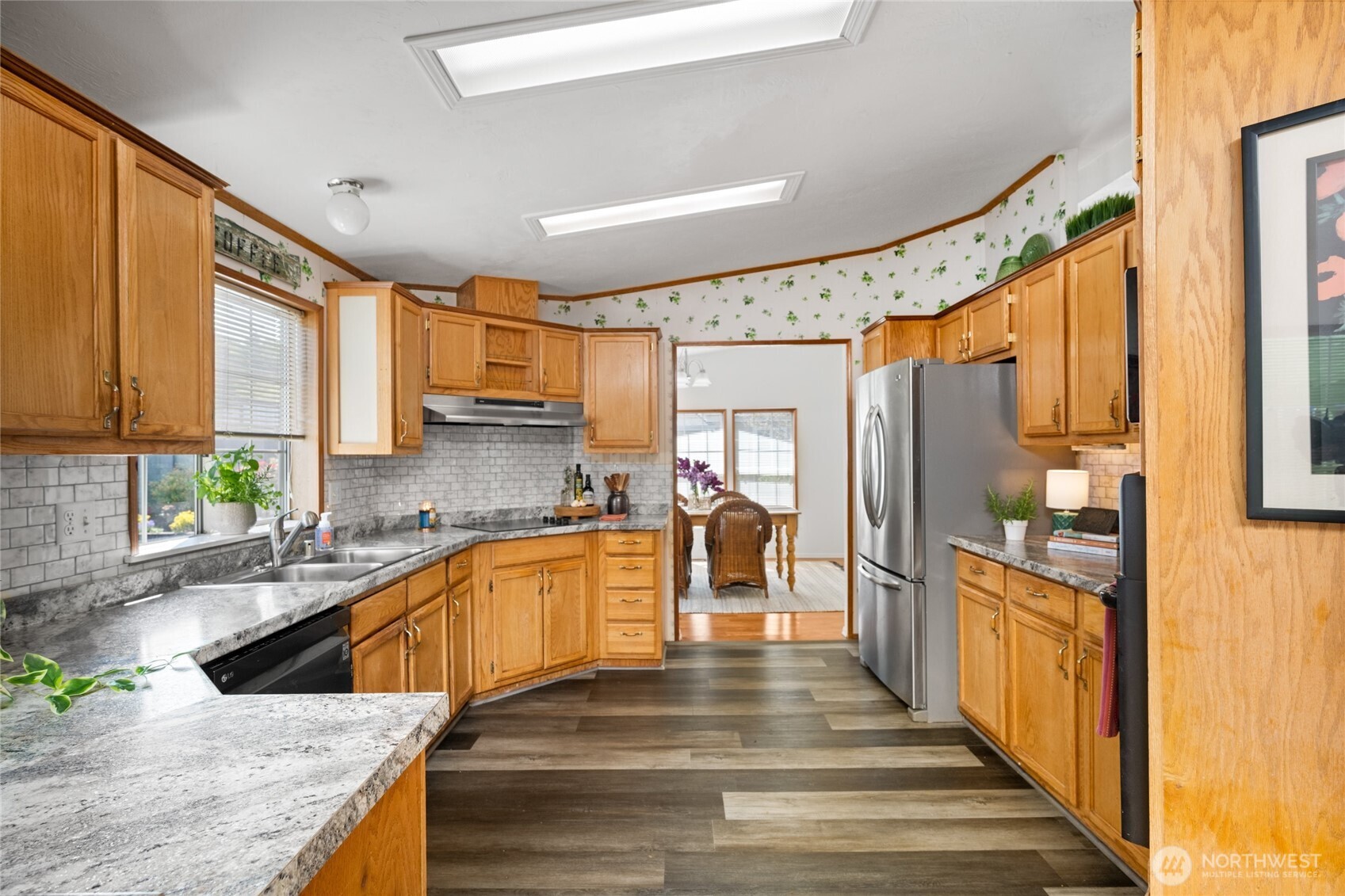 2015 24th Street, Unit 101 Bellingham, WA 98225 - Photo 13 of 24 a large kitchen with granite countertop a large window and stainless steel appliances