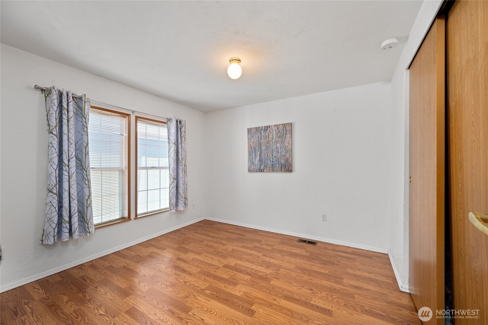 2015 24th Street, Unit 101 Bellingham, WA 98225 - Photo 22 of 24 a view of empty room with wooden floor and fan