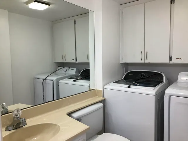a view of a kitchen with sink and washer