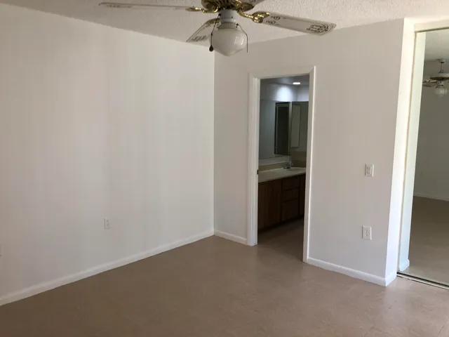an empty room and a chandelier fan in closet