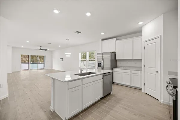 a kitchen with stainless steel appliances a refrigerator stove microwave and sink